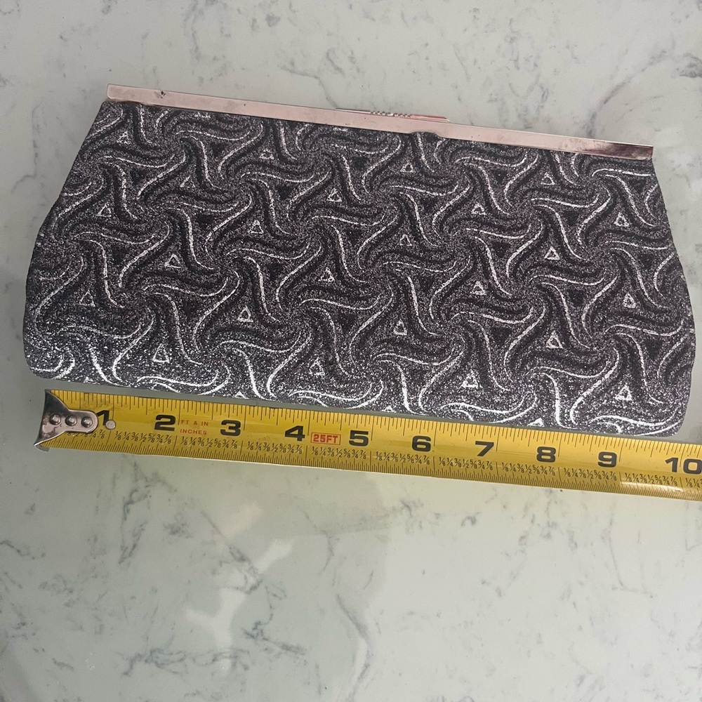 Sparkly 9.5” Metallic Black &Silver Ladies Clutch adds elegance to any occasion.